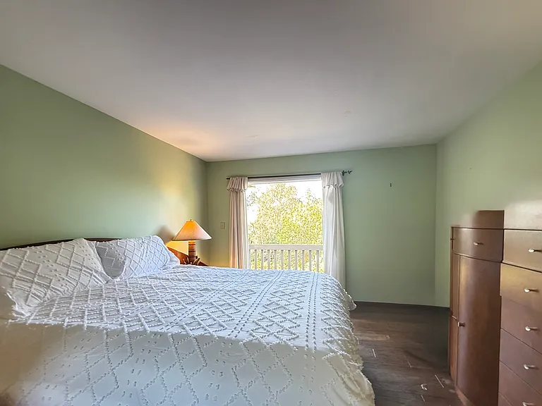 Master bedroom includes French doors to patio with beautiful view and gate to exit out to grounds