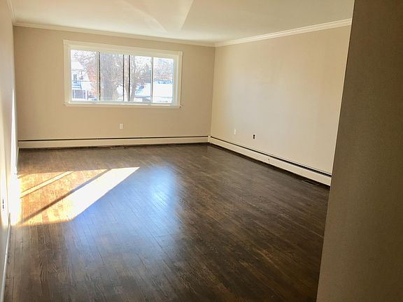 Spacious Living Room with Real Wood Flooring