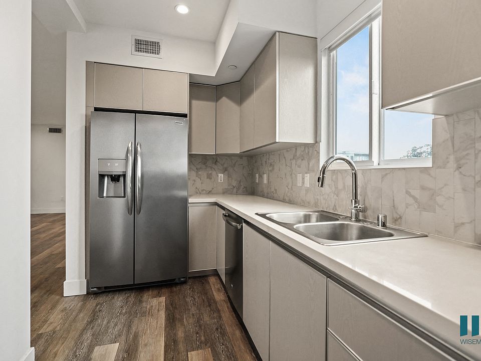 Kitchen with Stainless-Steel Refrigerator, Dishwasher, Stove, and Microwave Oven