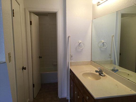 Master vanity area towards tub area. To left is door to walk-in closet.
