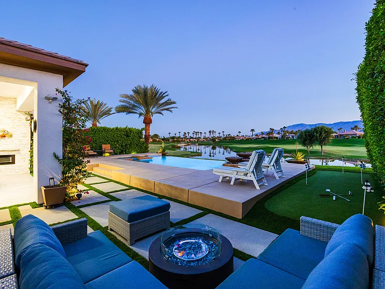 Cozy up around the fire pit with gorgeous sunset views over the mountains and golf course!