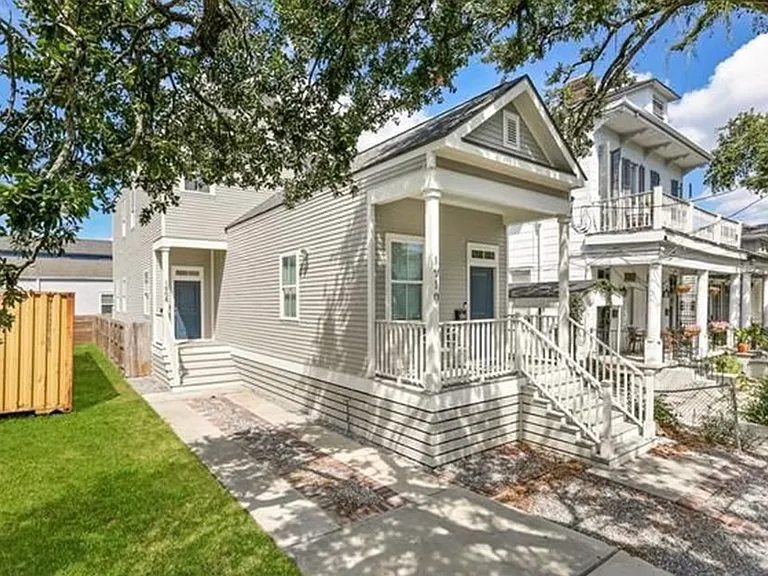 Street view. The two-car driveway belongs with the listing (1908 unit). The larger front porch belongs to the other unit in the duplex (1910 unit). The front door for the listing (1908 unit) is the blue door at the back of the driveway.