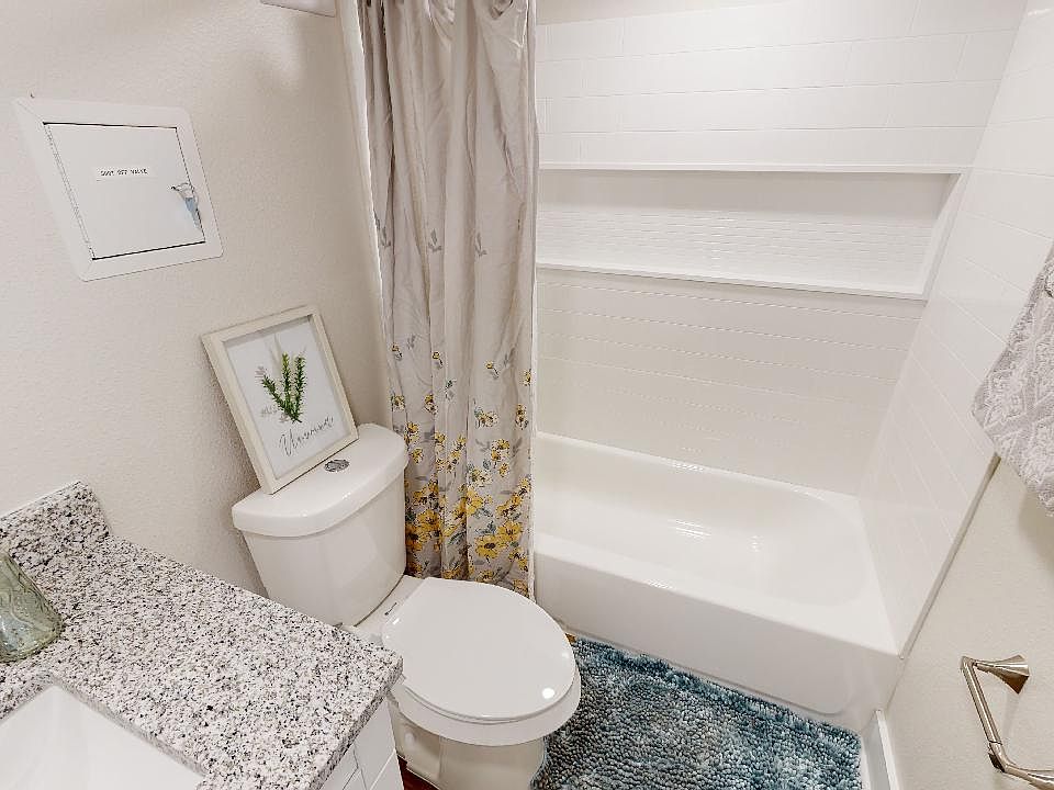 renovated bathroom with granite countertop