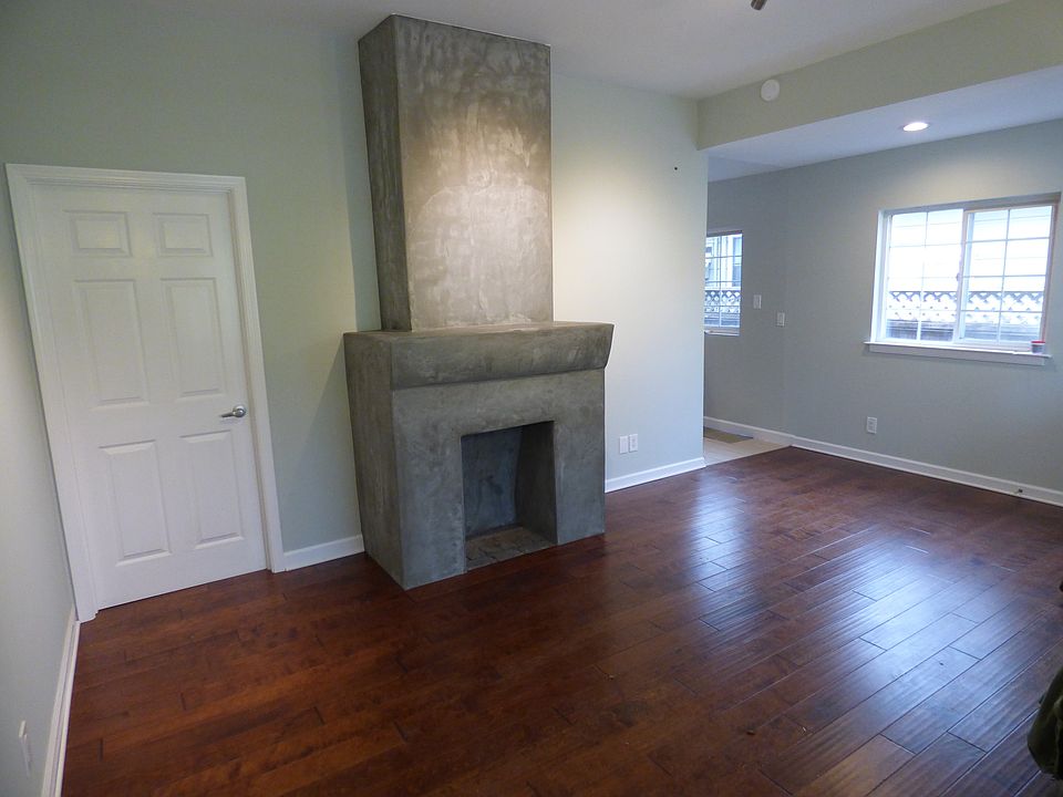 living area, NEW hardwood, ornamental fireplace.
