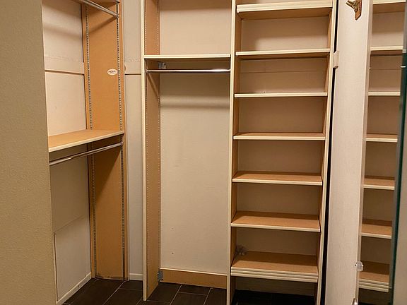 Walk in closet in primary bedroom