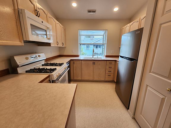Functional kitchen with ample cabinetry and clean, well-maintained finishes