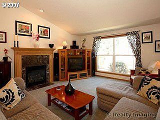 Great room with gas fireplace, vaulted ceiling and ceiling fan