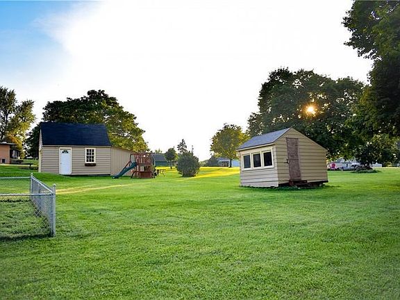 View of the detached 1 car garage, the chicken coop (seller just using this for storage at the present time), and also a portion