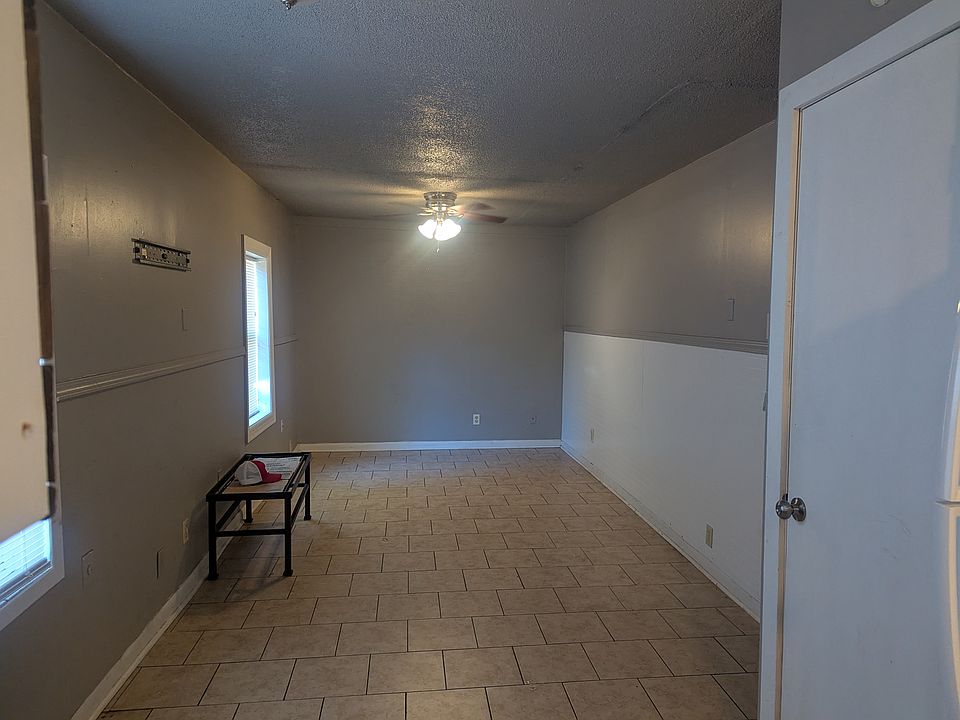 Living room and storage closet by kitchen
