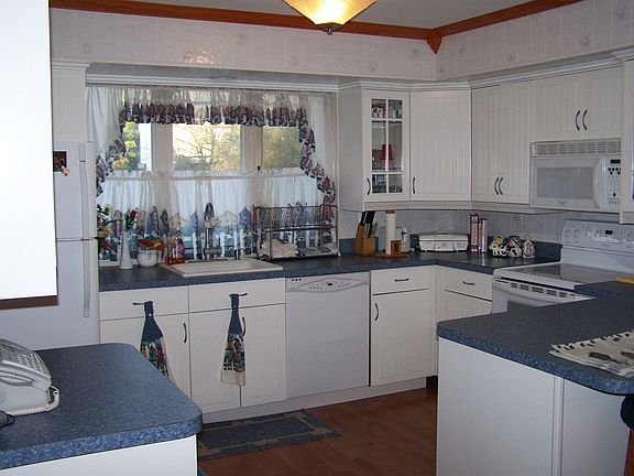 New kitchen with loads of counter space, cabinets, smooth-top stove, diswasher