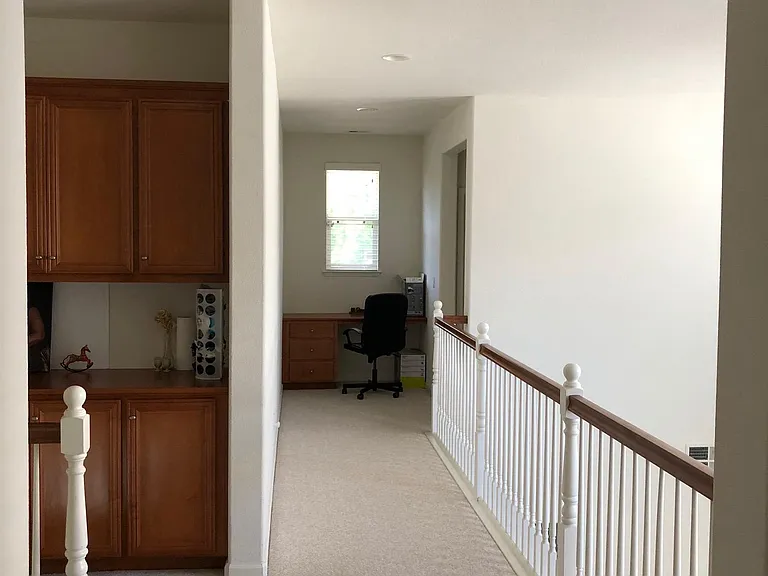 Aisle with cabinet space, and a working desk