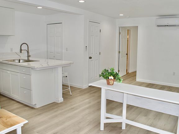 View inside front door. Table separats entry from living area.