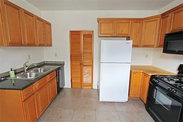 Premium cabinetry, granite and butcher-block countertops, and dishwasher.