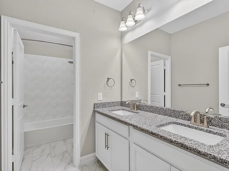 Dual vanity with granite countertop and integrated sinks