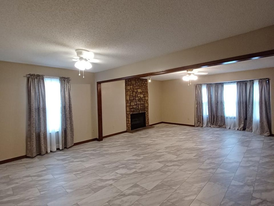 Very large living and dining room with beautiful stone gas log fireplace