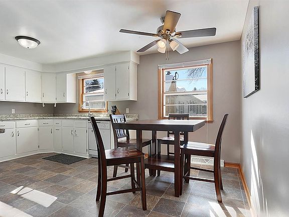 Dining area with updated lighting/ceiling fan.