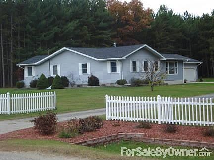 Front of the House : White picket fence with some beautiful low maintenance landscaping