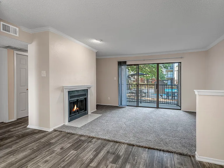 Spacious living room with fireplace and patio access for indoor-outdoor living.