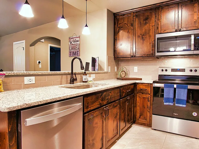 The kitchen offers stainless steel appliances, a breakfast bar with seating for 3. Refrigerator included.