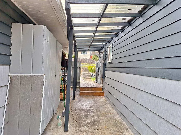 covered breezeway with attached garden storage cupboard
