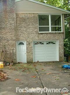 Side of house : New garage door and entry door.