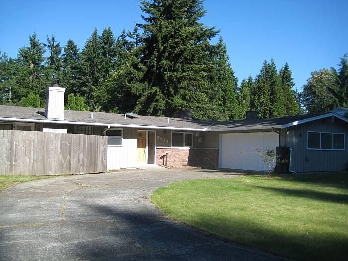 front of the house and spacious two car garage with large window.