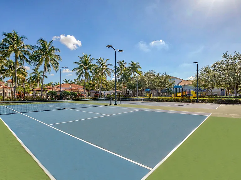 Luxury tennis court amongst other outdoor amenities