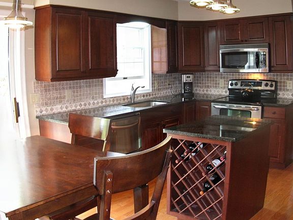 KITCHEN WITH GRANITE COUNTERTOPS AND CHERRY CABINETRY