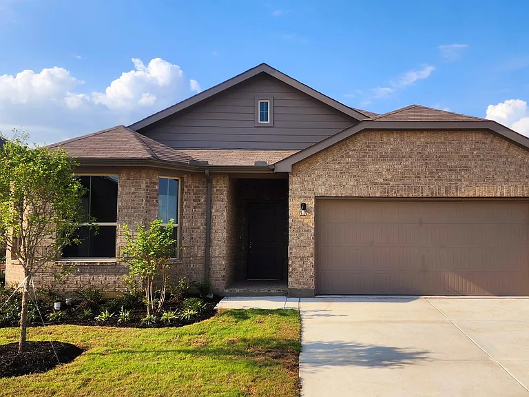 Front elevation. A storm house is also installed in addition to the main door at front.
