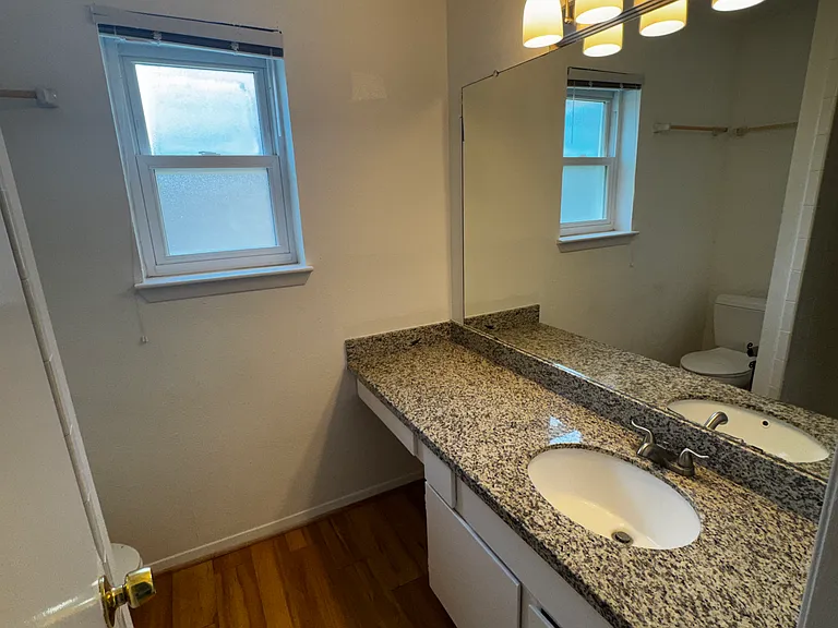 Primary bedroom's bathroom with vanity area.