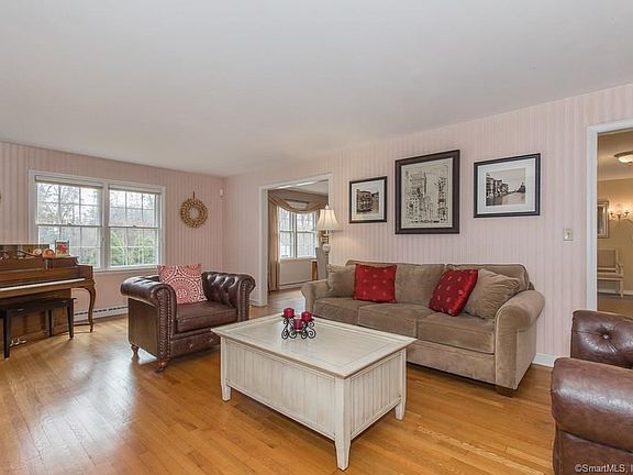 Living room with fireplace leads to dining room and enclosed porch.