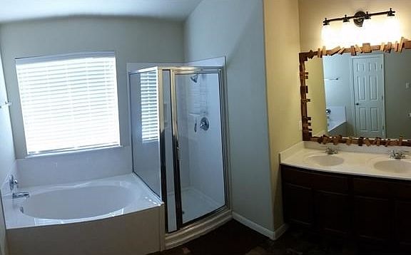 Spacious master bath with tub/shower combo and double sinks