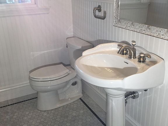 Guest half-bath with Carrara marble floor.