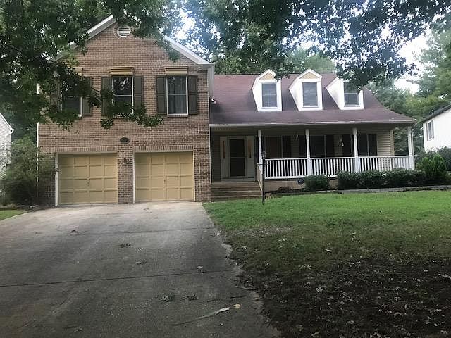 Single family home with large front porch and two car garage