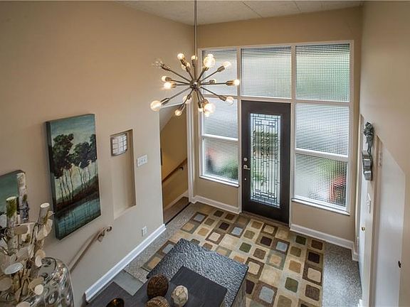 Oversized Entry with A Spectacular Light Fixture & Natural Lighting!