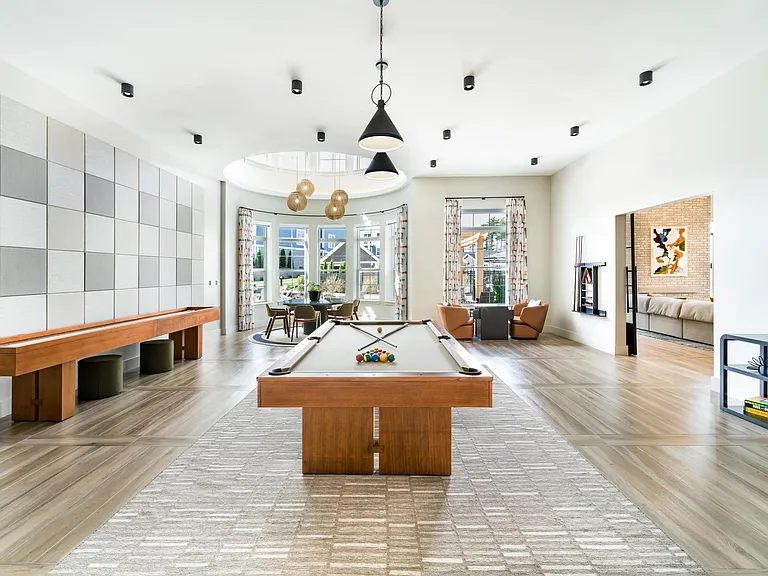 The resident lounge offers an inviting mix of seating areas, a billiards table, and shuffleboard_perfect for relaxing or hosting friends.