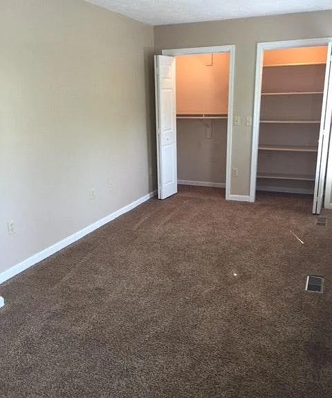 This bedroom is on the front side of the house. It has two good-size closets and three windows.