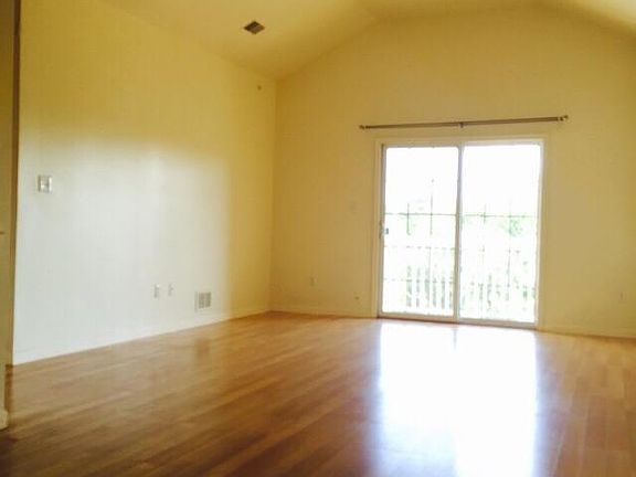 Living Room with high cathedral ceiling and balcony view