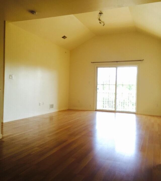 Living Room with high cathedral ceiling and balcony view