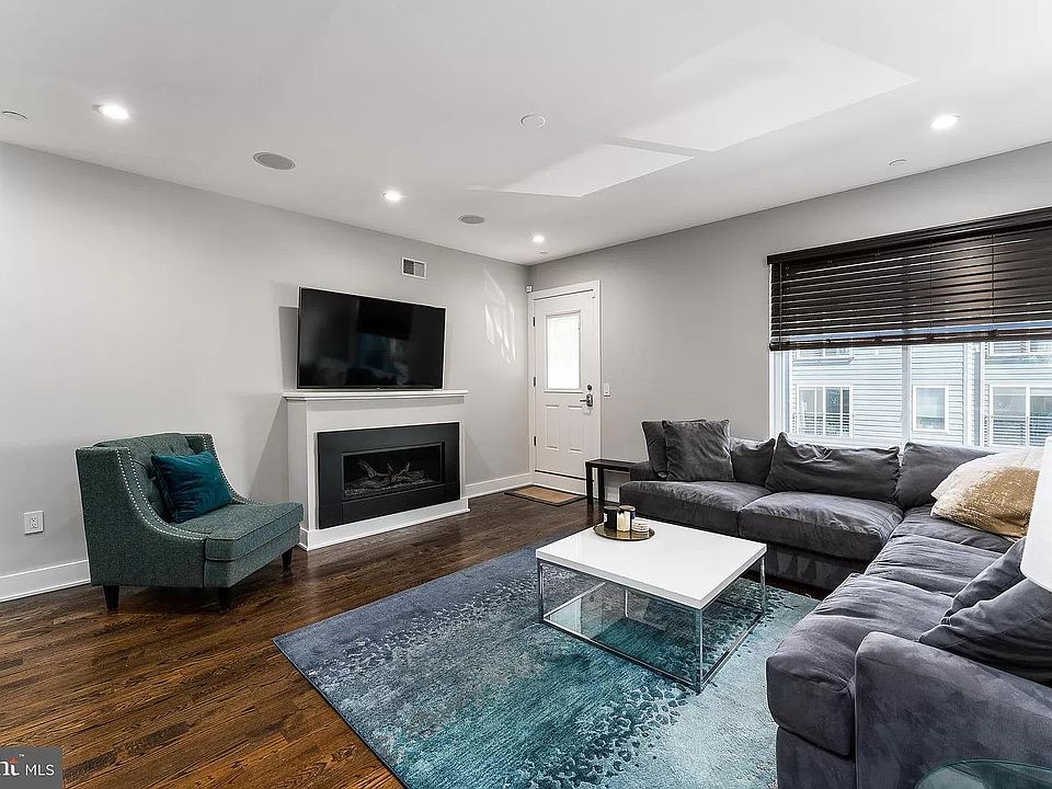 Your living room with the mounted TV and fireplace.
The door leads to the parking.