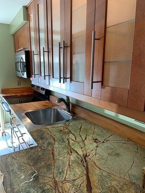 Rain forest marble. Task lighting. Lighted cabinets. Deep stainless sink w new faucet.