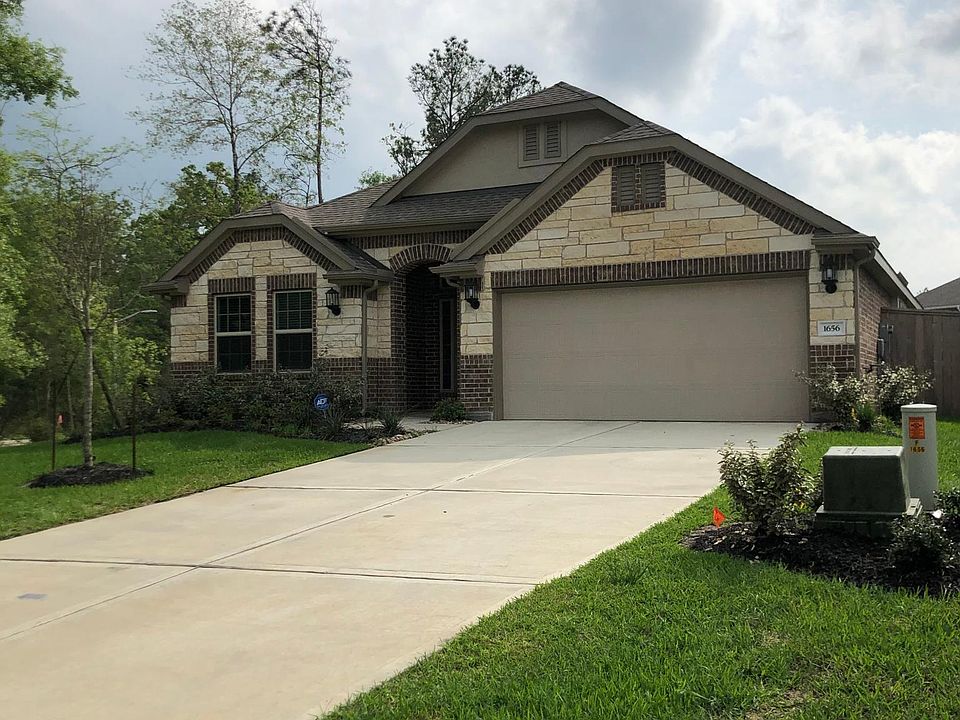 Beautiful stone and brick elevation on a corner lot. Three trees in the front yard with sprinklers.