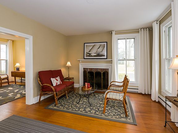 Living room with floor-length window with views of the Chestnut Street on the front and St. Michaels Museum on the side.