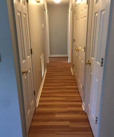 Hall with storage closets on the left and right and the washer/dryer double doors on the right.