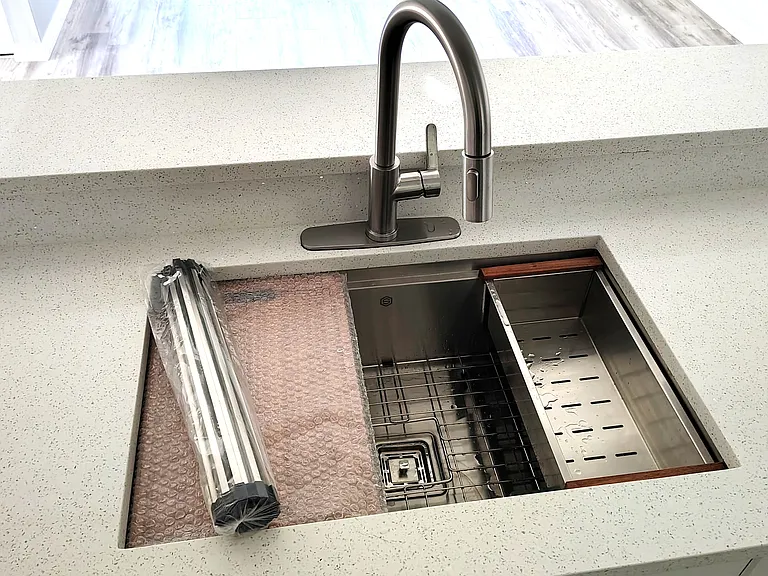 New sink, extendable faucet, dish rack, and cutting board.