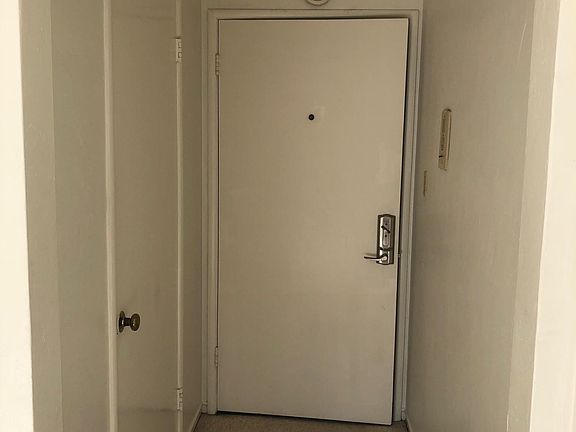 Looking back at front door and entry hall closet.