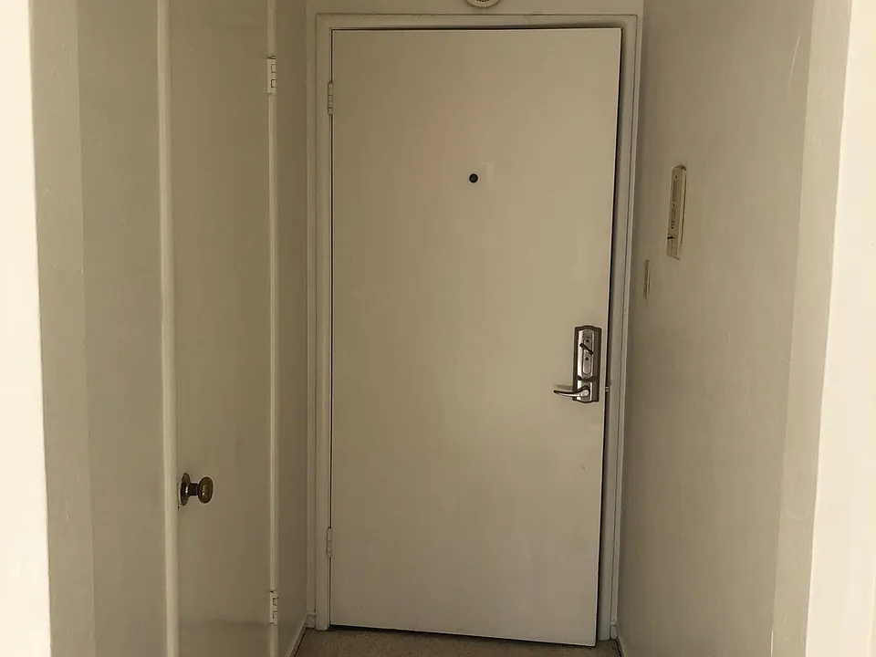 Looking back at front door and entry hall closet.