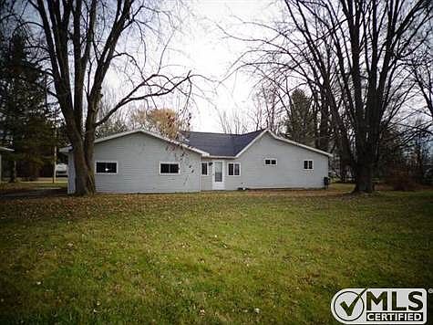 Back of home with large yard