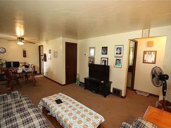 Large 13x11 Living Room opens into 11x8 Dining Room. Plaster Walls, Wood Trim Work & Marble Sills.Ceiling Fan Light in Dining Ro