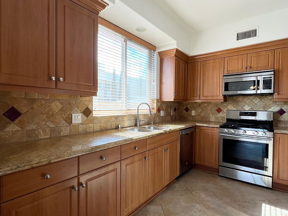 Left half of kitchen with included dishwasher, gas range, and microwave.